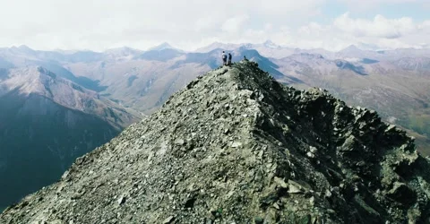 Drone flying over Mountain Peak with some Hikers Stock Footage 236638954