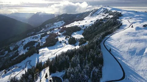 Drone flying over the mountains in landscape with lots of snow and trees Stock Footage 142876533
