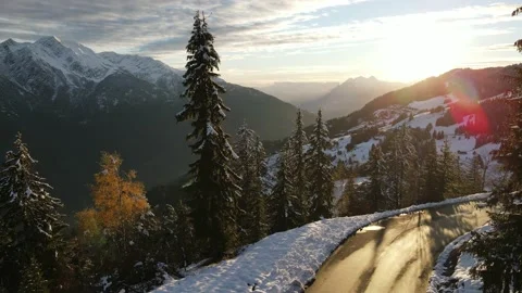 Drone flying over the mountains in landscape with lots of snow and trees Stock Footage 142876641