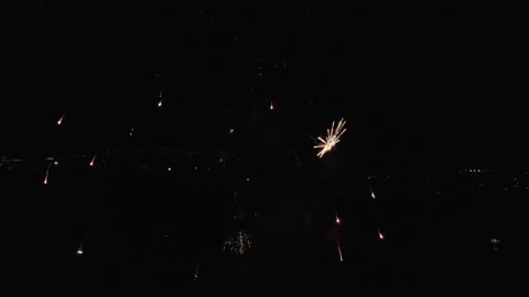 Drone flying over multicolored explosions of fireworks in the air. Aerial Stock Footage 229680203