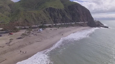 Drone Flying Over Ocean Backwards &amp; Ascending From Beach Raw Stock Footage 78875542