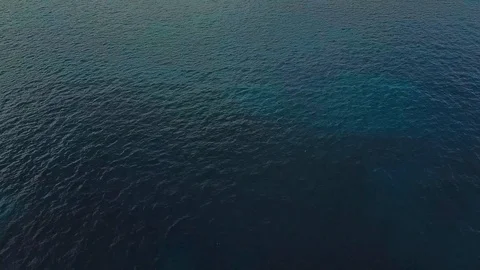 Drone flying over the ocean with breathtaking horizontal view of mountains and Stock Footage 94077360