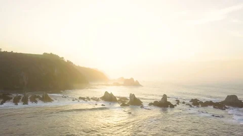 Drone flying over the ocean coast at sunset Stock Footage 81509633