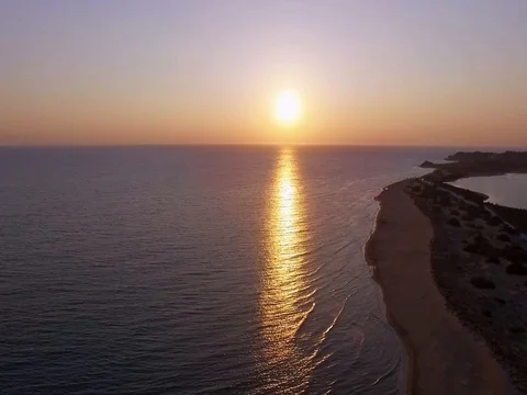 Drone flying over ocean in sunset Stock Footage 79615143
