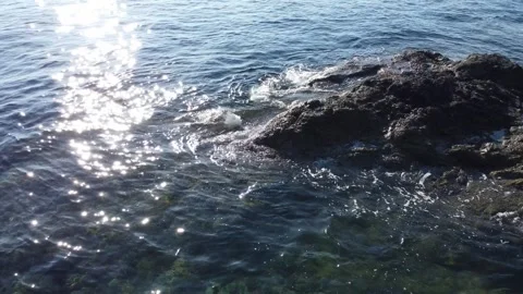 Drone flying over ocean waves on rocks with a sunset and moving clouds 스톡 동영상 279776284