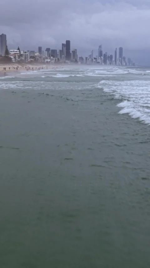 Drone flying over ocean waves toward Gold Coast skyline Queensland Australia Stock Footage 330976720
