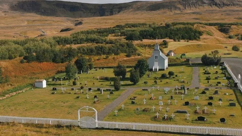 A drone is flying over an old Icelandic typical church Stock Footage 116115853