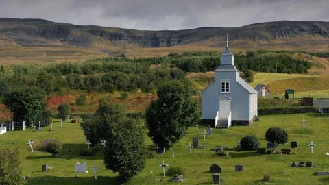 A drone is flying over an old Icelandic typical church Stock Footage 116119289