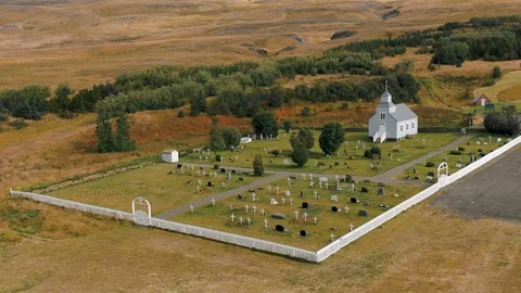 A drone is flying over an old Icelandic typical church Stock Footage 116121165