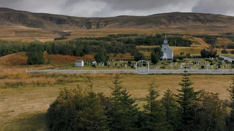 A drone is flying over an old Icelandic typical church Stock Footage 116122887