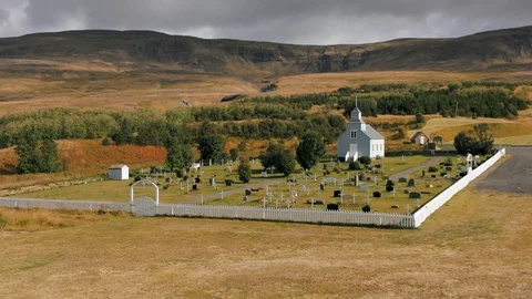 A drone is flying over an old Icelandic typical church Stock Footage 116124392