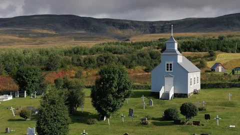 A drone is flying over an old Icelandic typical church Stock Footage 116125309