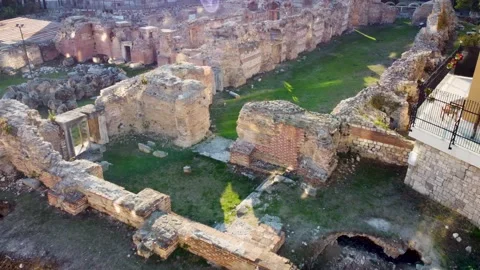 Drone flying over old Roman Thermae ruin with green grass Stock Footage 226292848