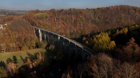 Drone Flying Over Old Viaduct in Mountain Gorge During Autumn Season Stock Footage 320839773