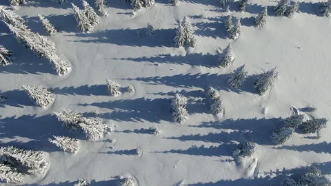 Drone flying over peak of mountain covered in deep snow. Snow-covered Christmas Stock Footage 123854923