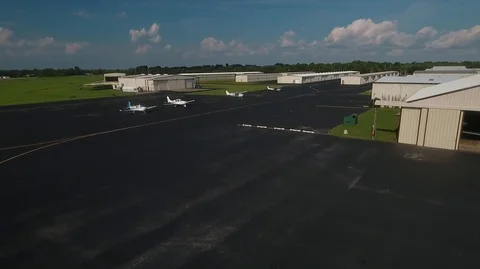 DRONE FLYING OVER PLANES AND HANGARS Stock Footage 93402216