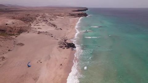 Drone Flying Over Playa del Aljibe de la Cueva with Man and Parasail Stock Footage 309022115
