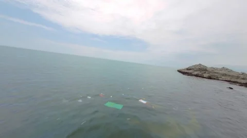 Drone flying over polluted ocean with trash floating over water marine litter Stock Footage 304644310