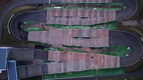 Drone flying over a professional bmx race track with jumps and asphalt turns Stock Footage 337093059
