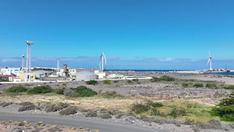 Drone Flying Over Raw Nature with Wind Turbines and Ocean in Distance Stock Footage 310017848