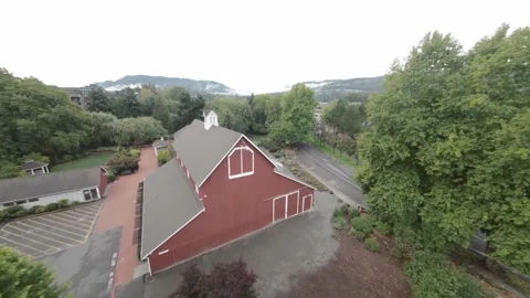 Drone Flying Over a Red Barn in Wooded Area (Desaturated) Stock Footage 252632588