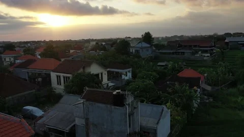 Drone Flying Over Rice Fields Reveals Bali Canggu Houses and Rooftop Stock Footage 144046674