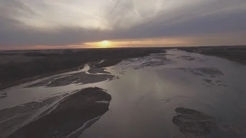 Drone Flying Over River Ascending To Sunset Raw Stock Footage 78869577