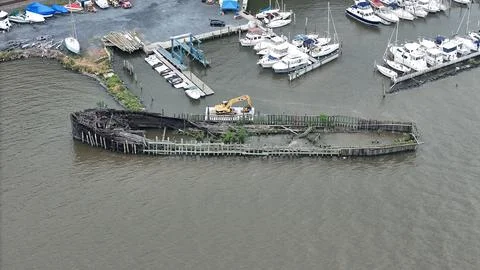 Drone Flying over River on a Cloudy Day with Shipwreck Stock Photos