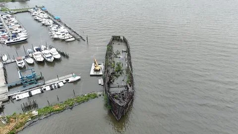 Drone Flying over River on a Cloudy Day with Shipwreck Stock Photos