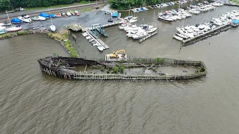 Drone Flying over River on a Cloudy Day with Shipwreck Stock Photos