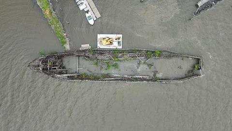 Drone Flying over River on a Cloudy Day with Shipwreck Stock Photos