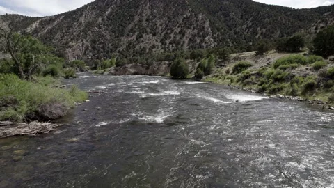 Drone Flying over River Rocky Mountains 4K Video stock 198715604