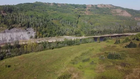 Drone flying over river with rolling hills on sunny day Stock Footage 253514048