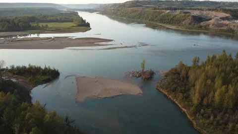 Drone flying over river with sandy beach and forest on sunny day Stock Footage 280006831