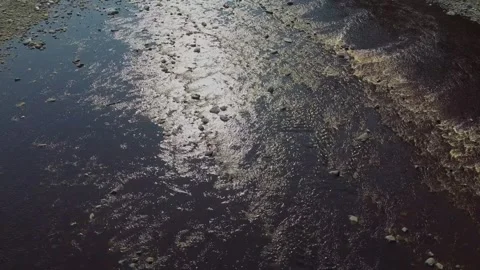 Drone flying over river on sunny day with fast moving water and rocks 스톡 동영상 279938339
