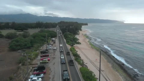 Drone Flying Over A Road Next To A Beach In Oahu, Hawaii Stock Footage 154170767