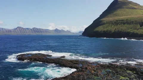 Drone flying over rock beach, puddles. Aerial view of rough blue sea, green Vídeo Stock 194110148