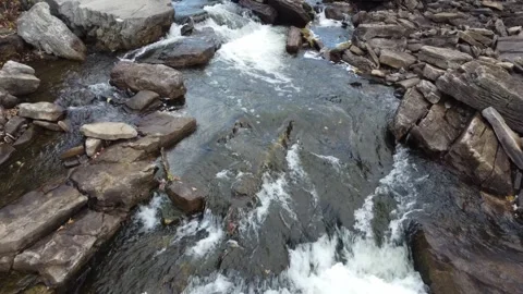 Drone flying over rocky stream with flowing water Stock Footage 289551360