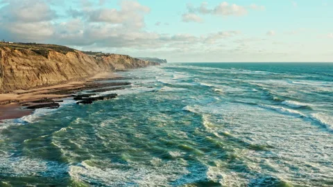 Drone is flying  over rolling ocean waves to the rocky shore. Aerial view o.. Stock Footage 239580603