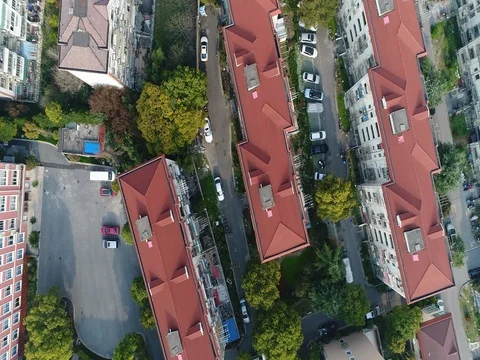 Drone flying over roofs, lanes and car parking in residential area Stock Footage 77073760