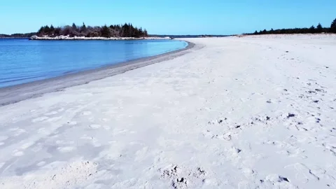 Drone flying over sand and water at Carter's Beach, Nova Scotia Stock Footage 155552158