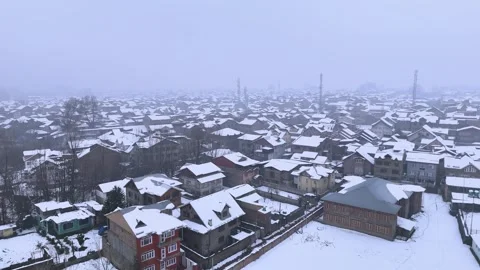 Drone flying over a scenic snow-covered cityscape in Kashmir Valley Stock Footage 310224559