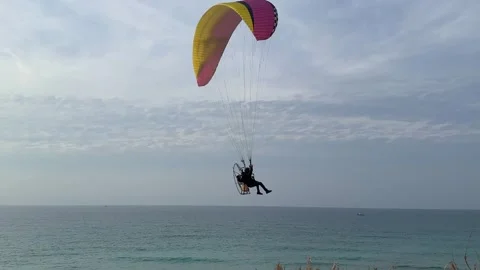 A drone flying over the sea with a deployed parachute Video stock 295506555
