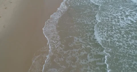 Drone flying over the sea looking down with waves rolling in at Mae Pim Stock Footage 108414601