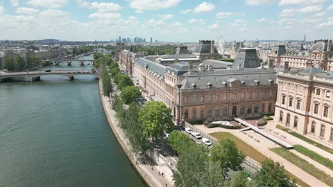 Drone flying over Seine river along Louvre Museum in Paris. Aerial forward Stock Footage 217658466