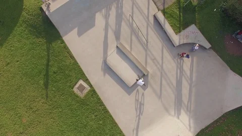 Drone flying over a skatepark where kids are skating and playing Stock Footage 84016348
