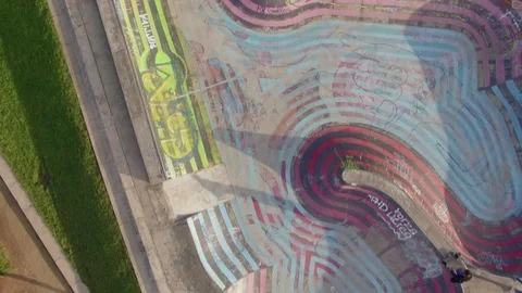 Drone flying over a skatepark where kids are skating and playing Stock Footage 84016356