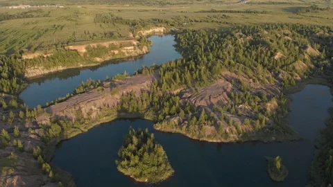 Drone flying over small lake surrounded by sparse vegetation Stock Footage 120165199