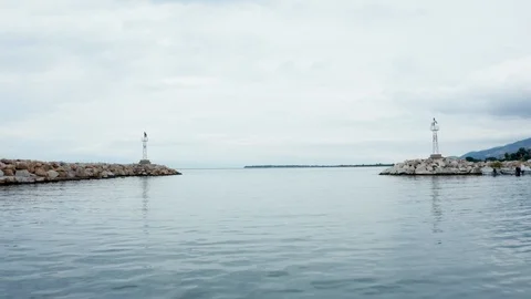 Drone flying over small lighthouses at the exit of the harbor Stock Footage 117429779