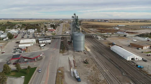 Drone Flying Over Small Rural Town Circling Grain Silos Near Train Tracks Stock Footage 229183478